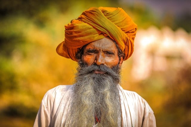 man wearing orange headdress